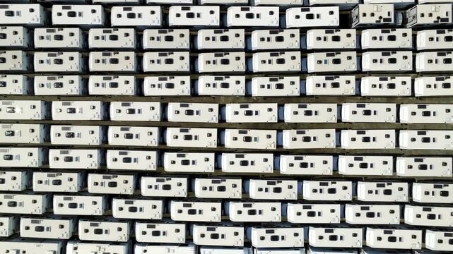 Aerial View Of Imported Recreational Vehicles Parked In Parallel Rows At Storage Lot In Richmond, Canada. overhead shot