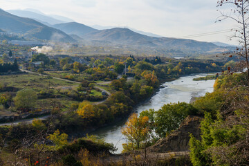 Autumn landmark near the Mtskheta with Kura river and mountain forest. © vahanabrahamyan