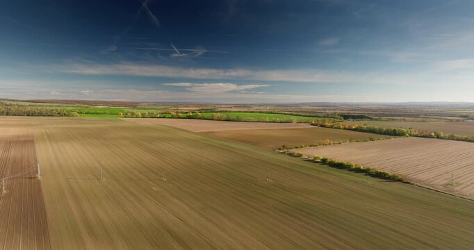 High-altitude drone shot of vast patchwork fields and rural countryside in South Moravia, Czech Republic.