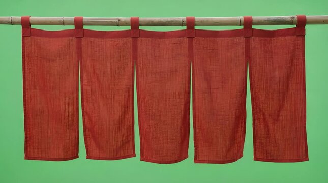 Japanese Style Red Fabric Doorway Curtain Hung on Bamboo Pole Against Green Screen
