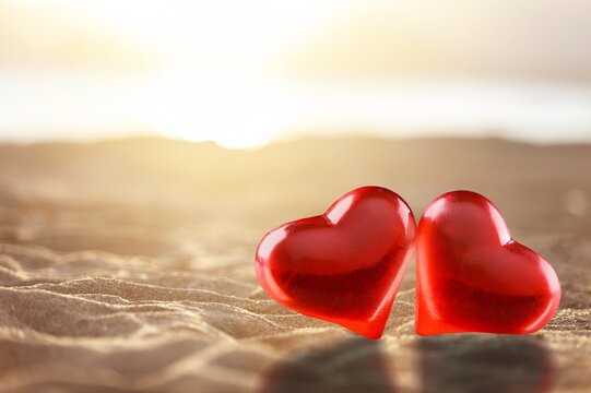 Beautiful red heart on beach for love concept