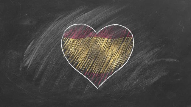 National flag of Spain in heart shape drawn with colored chalk on a blackboard. Spanish language, Learning Spanish.
