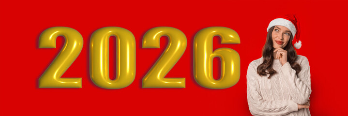 Obraz premium A woman wearing a santa hat thinks about the year 2026 in a set with large golden numbers against a red background. The collage presents a festive and imaginative mood during the holidays.