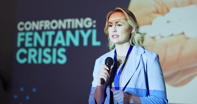Presentation, woman and talking in speech with information, drug crisis awareness and fentanyl epidemic. Speaker, mic and public speaking in seminar for research findings, workshop or risk management