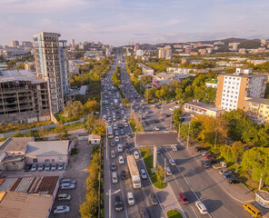 Fototapeta premium Rush hour traffic in Vladivostok Vtoraya Rechka district, Primorye, with Soviet era blocks and urban sprawl. 