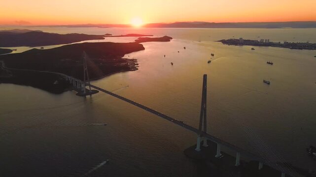 Russky Bridge in Vladivostok, beautiful panoramic video of Eastern Bosphorus strait in Far East of Russia during sunset.
