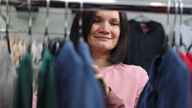 Pregnant woman. Clothing store. Expectant mother.Slow motion video.High quality 4k footage