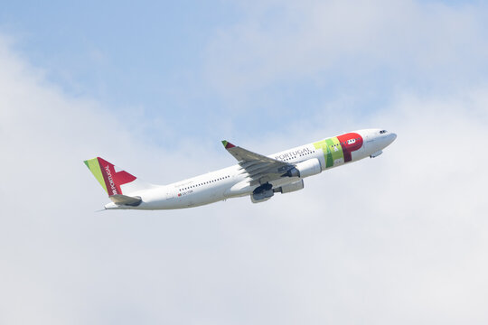 Tap air portugal airbus a330 taking off into blue sky