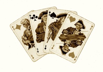 A hand of vintage playing cards showing four of the same value isolated on a white background.