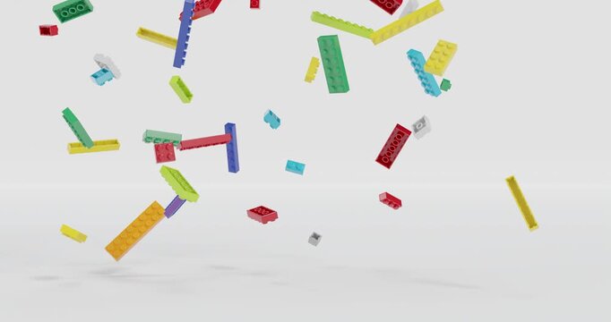 Toy plastic building bricks falling and rotating in slow motion footage with grey background. 3D 4K FX animation.
