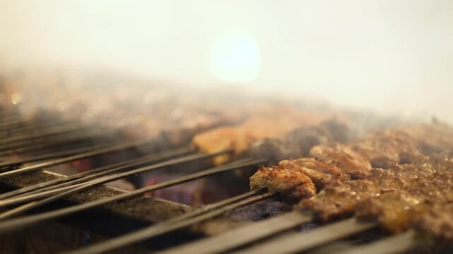 Cinematic close-up of traditional Turkish kebab skewers grilling over hot charcoal with smoke and steam. Perfect for Turkish cuisine, barbecue, street food and culinary background footage.