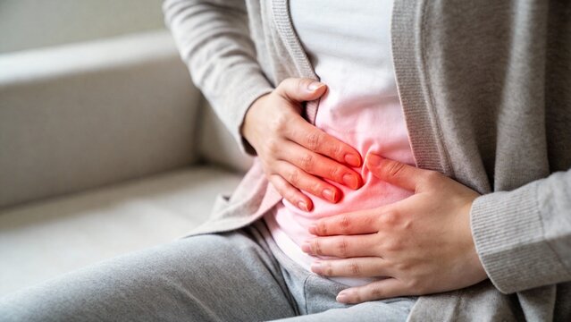 Woman suffering from lower abdominal pain at home
