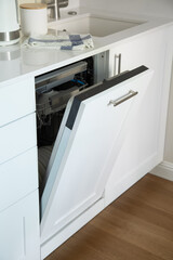 Open dishwasher with clean dishes