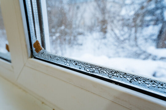 Ice Buildup Windows, Condensation And Cold Drafts Observed, Frozen Glass Surface Indicates Insulation Issues, Signs Of Moisture And Cold Infiltration On Window Frame During Winter