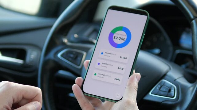 High-quality shot of a sleek mobile banking UI showing a 2000 dollars budget breakdown. Ideal for fintech promos, mobile app reviews, and digital accounting. Realistic car setting highlights