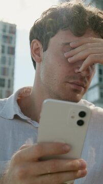 Stressful disappointed Caucasian business man with mobile phone businessman male guy suffering with smartphone fail error connection lost money online betting failure agent specialist upset in city