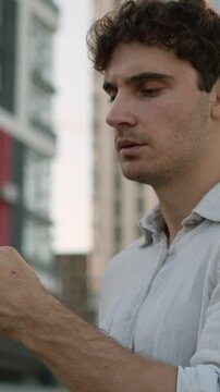Thinking Caucasian business man with mobile phone think in city downtown pondering puzzled businessman hesitate guy male employer deciding solution holding smartphone ponder idea unsure with internet
