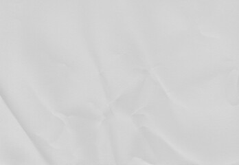 Fototapeta premium High-resolution white crumpled paper texture with soft folds and natural creases. Neutral background ideal for overlays, mockups, posters, packaging, editorial design, and minimalist compositions.
