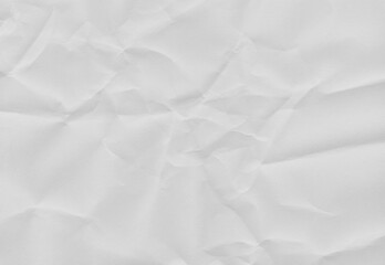 Obraz premium High-resolution white crumpled paper texture with soft folds and natural creases. Neutral background ideal for overlays, mockups, posters, packaging, editorial design, and minimalist compositions.