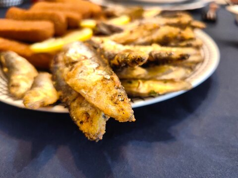 Fried small fish, sardines or smelts, served on plate