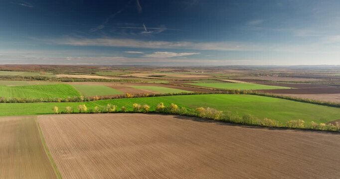 Scenic drone footage of green rolling agricultural fields in Czech Tuscany near Moravsky Krumlov, Czech Republic.