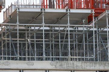 Scaffolding structure at construction site with metal beams and platforms, showcasing industrial engineering and urban development. framework supports building progress