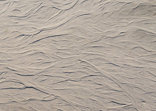 Aerial view of textured sand patterns revealing a stark contrast between light and shadow, creating an abstract landscape, Selfoss, Sveitarfelagid Arborg, Iceland.