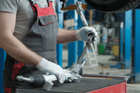 Car service.Replacing the steering rack.The mechanic checks the compatibility of the steering rack and the steering driveshaft.