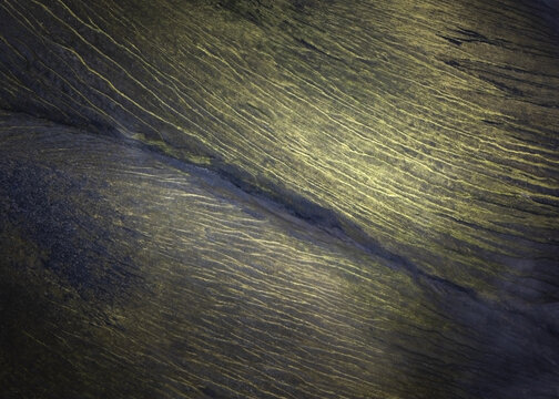 Aerial view of the expansive landscape etched with linear patterns, revealing the earth's subtle textures and contrasting light, Myvatn, Thingeyjarsveit, Iceland.