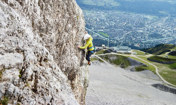 Austria, Innsbruck, Nordkette, woman climbing in rock wall