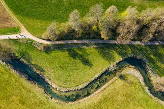 Germany, Baden-Wurttemberg, Lautertal, Aerial view of countryside dirt road stretching along winding Grosse Lauter river