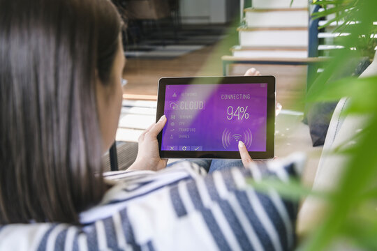 Young woman with tablet with smart home control functions