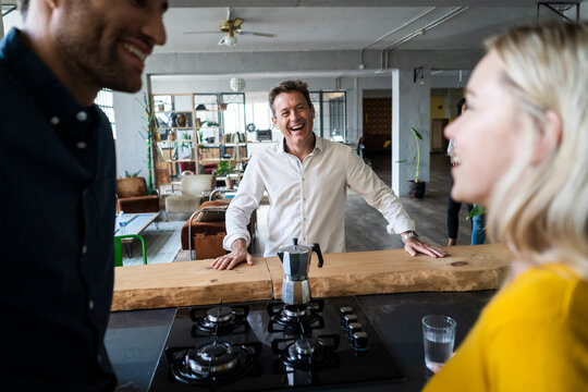 Happy business team having a break in loft office