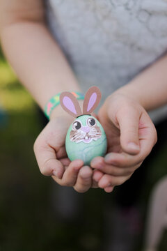 Close-up of girl holding decorated Easter egg