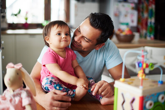 Smiling father with baby girl at home