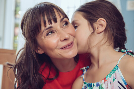 Daughter telling mother a secret