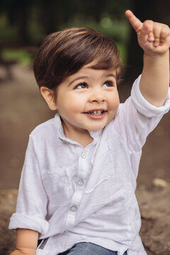 Portrait of smiling toddler raising his finger