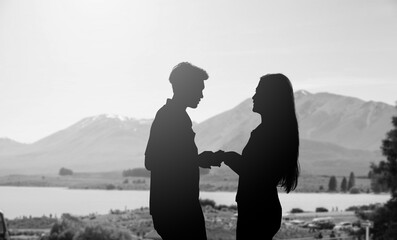 silhouette shadow of lover couple hold hand together and looking each other with love emotion on...