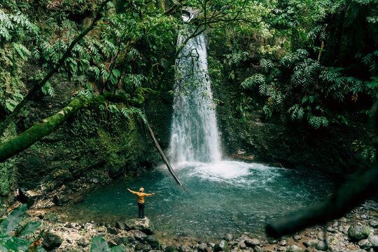 Rear view of man at a waterfall on Sao Miguel Island, Azores, Portugal