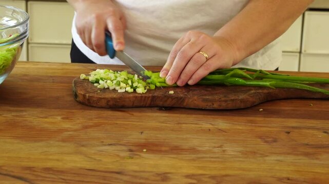 Woman cutting iceberg lettuce for salad
