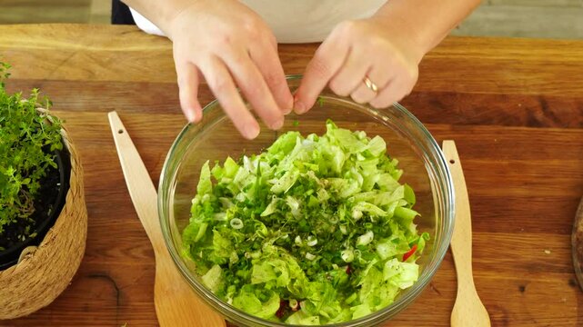 Woman cutting iceberg lettuce for salad
