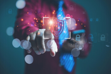 Obraz premium Businessman Activating a Digital Cyber Security Shield for Data Privacy Protection.