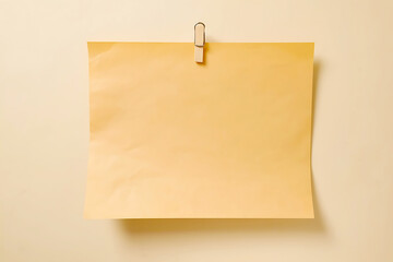 Brown kraft paper sheet pinned to a light wall with a wooden clothespin, offering a rustic and natural feel.