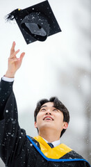 Throwing graduation caps into the sky at the winter graduation ceremony