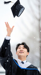 Throwing graduation caps into the sky at the winter graduation ceremony