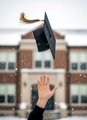 Throwing graduation caps into the sky at the winter graduation ceremony