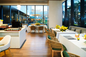 A buffet restaurant with yellow flowers on the tables