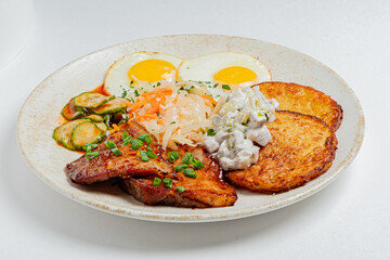 Enjoy a tasty breakfast with juicy pork, fluffy eggs, tangy salad, and crispy potatoes