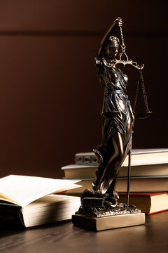 Lady Justice statue placed on a lawyer&rsquo;s desk in an office, reflecting everyday legal practice and the principles of justice. Concept law, justice, legal profession, office.