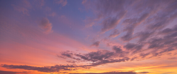 Fototapeta premium Breathtaking Cotton Candy Sunset Sky with Dreamy Pastel Clouds,A stunning wide-angle view of a twilight sky filled with soft, wispy clouds illuminated by vibrant shades of pink, purple, and orange,